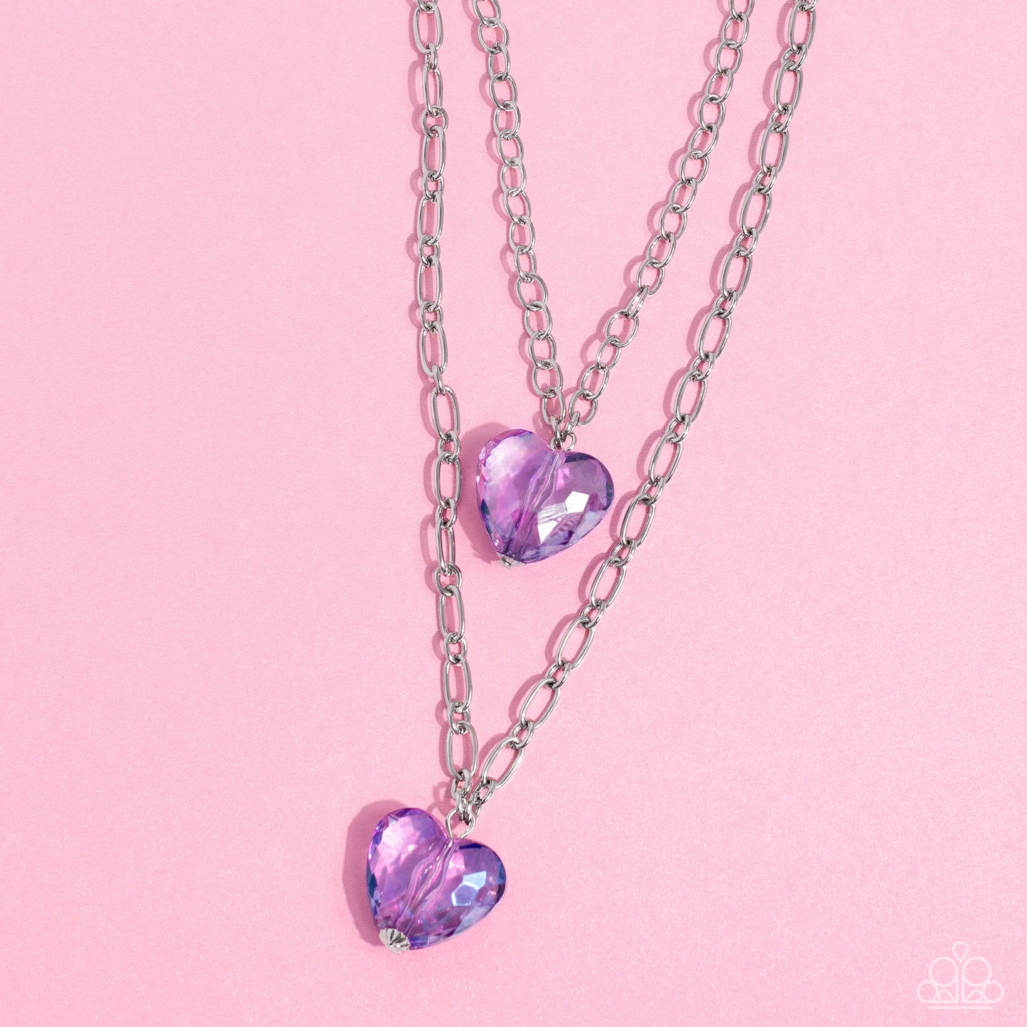 Layered Love Purple Heart Necklace - Paparazzi Accessories  Featuring a subtle iridescent shimmer, two glassy purple gem hearts are delicately suspended above one another on a paperclip and silver oval link chain for a whimsical double-stacked display. Features an adjustable clasp closure.  Sold as one individual necklace. Includes one pair of matching earrings.  SKU: P2WH-PRXX-446XX