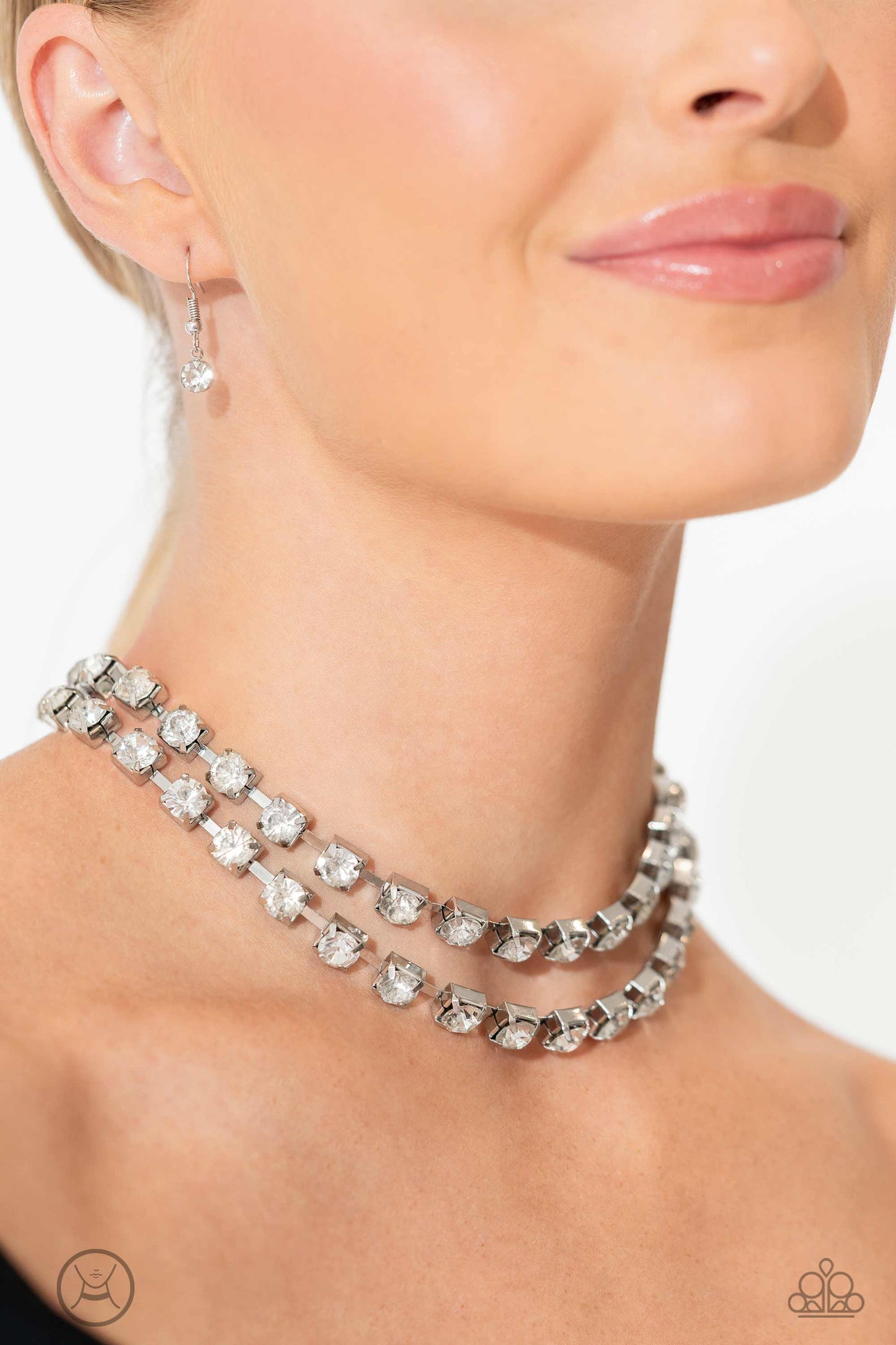 Glistening Gallery White Rhinestone Choker Necklace - Paparazzi Accessories  Featuring pronged silver fittings, strands of oversized, glittery white rhinestones connect with rows of silver box chains around the neck for a glittery twist. Features an adjustable clasp closure.  Sold as one individual choker necklace. Includes one pair of matching earrings.  P2CH-WTXX-070XX