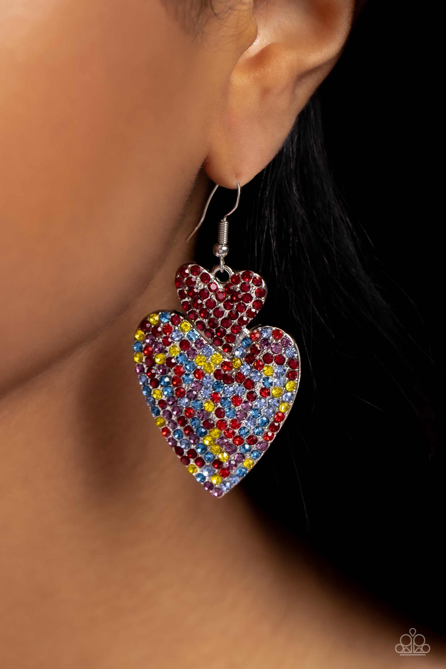 Flirting Flourish Red Heart Earring - Paparazzi Accessories  Embossed in dainty rhinestones, a red rhinestone-covered silver heart frame delicately links with a larger silver heart frame featuring red, light red, blue, yellow, and pink rhinestones for a flirtatiously vibrant look. Earring attaches to a standard fishhook fitting.  Sold as one pair of earrings.  P5ST-RDXX-024XX
