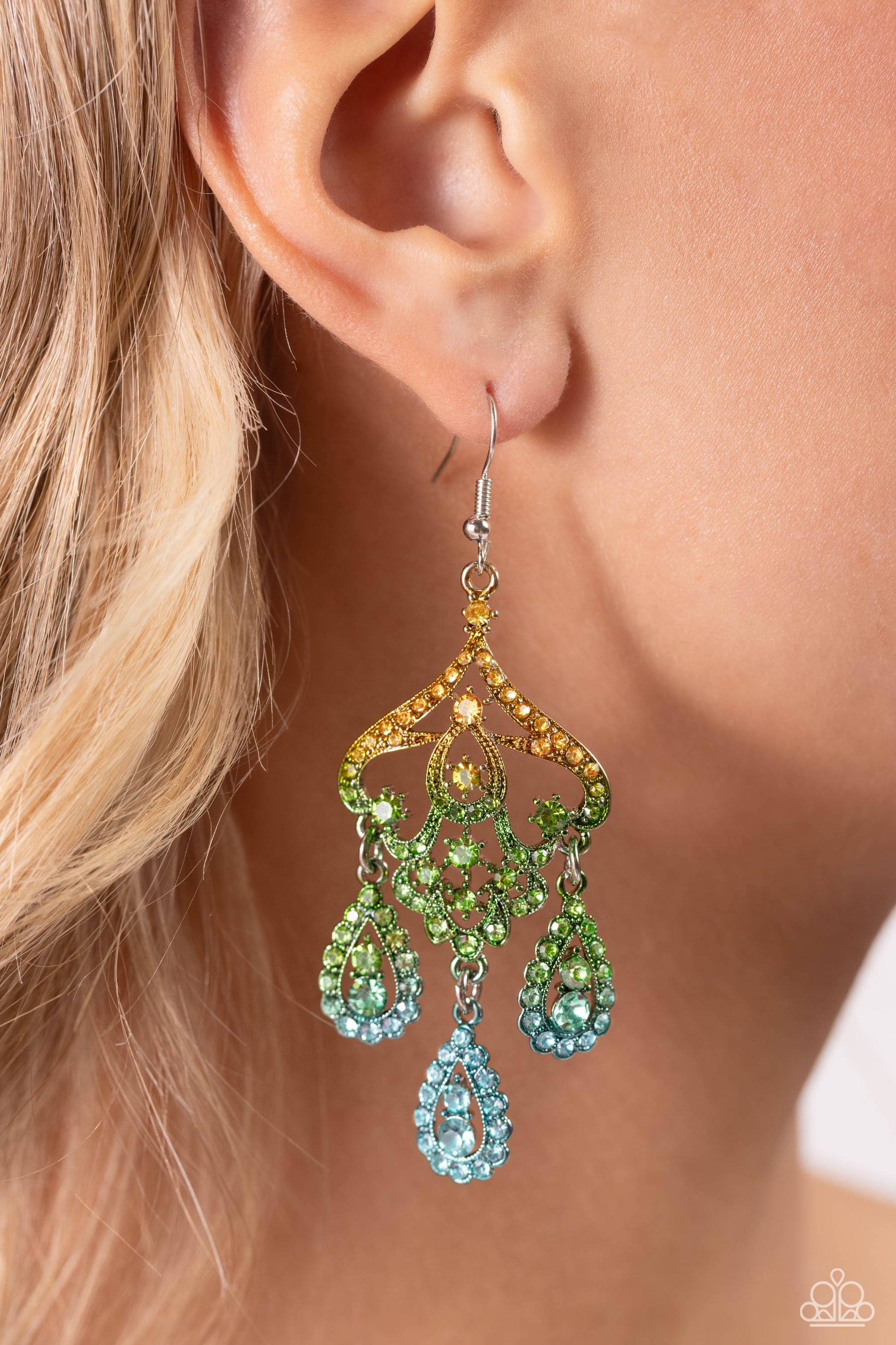 Chandelier Command Multi Earring - Paparazzi Accessories  Three rhinestone-encrusted teardrops drip from the bottom of an ornate decorative frame, creating an elegant fringe. The decorative frame swirls with ombré rhinestones that go from yellow to green to blue shades in varying sizes for a timelessly over-the-top sparkle. Earring attaches to a standard fishhook fitting.  Sold as one pair of earrings.  P5SE-MTXX-172XX