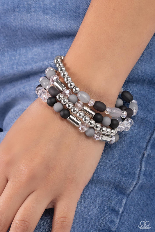 Glassy Gait Black Stretch Bracelet - Paparazzi Accessories  A shimmery collection of silver beads and accents, glassy long black and gray beads, faceted clear beads, and black and gray acrylic beads are threaded along stretchy bands around the wrist, creating glistening layers.  Sold as one set of four bracelets.  P9WH-BKXX-198XX