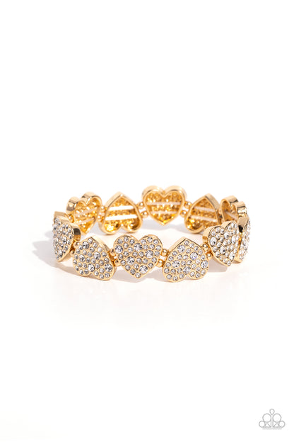 Headliner Heart Gold Stretch Bracelet - Paparazzi Accessories  Dotted with various sizes of dainty white rhinestones, sleek gold hearts alternating in direction link together around the wrist along a stretchy band for a flirtatious finish.  Sold as one individual bracelet.  SKU: P9RE-GDXX-407XX