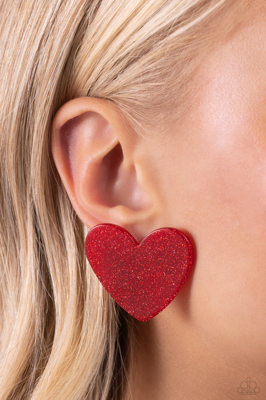 Sparkly Sweethearts Red Heart Post Earring - Paparazzi Accessories  Dusted in sparkles, a red acrylic flat heart frame shimmers and shines from the ear for a flirtatious finish. Earring attaches to a standard post fitting.  Sold as one pair of post earrings.  SKU: P5PO-RDXX-046XX