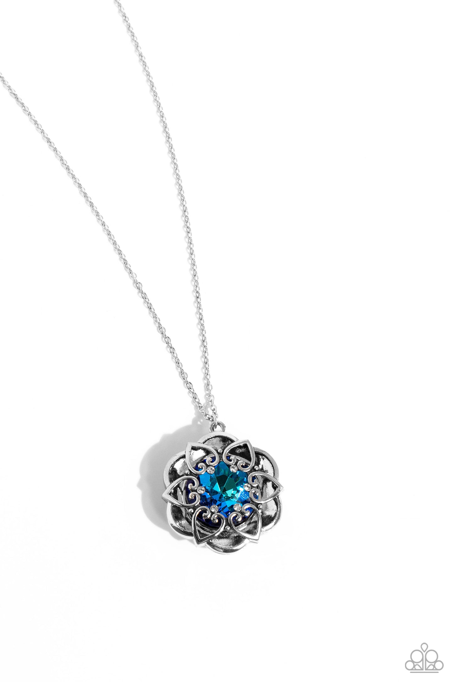Pressed in the center of an oversized, thick silver floral frame, a blue UV gem glimmers from the chest. Intricate silver hearts, sprinkled with dainty white rhinestones, encircles the inner circle of the floral frame to create ornate, 3D petals. The whimsical pendant swings from the bottom of a lengthened, dainty silver chain for a seasonal look. Features an adjustable clasp closure.  Sold as one individual necklace. Includes one pair of matching earrings.  P2RE-BLXX-414XX