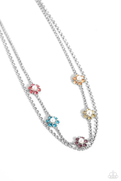A SQUARE Beauty Multi Necklace - Paparazzi Accessories  Featuring silver square fittings, white rhinestones cascade into two layers below the collar adding glitzy movement to the sparkling centerpiece. Infused along the uppermost chain, a glitzy collection of pearl-dotted flowers with rose, blue, amethyst, yellow, and peachy rhinestone petals creates a splash of whimsical color. Features an adjustable clasp closure.