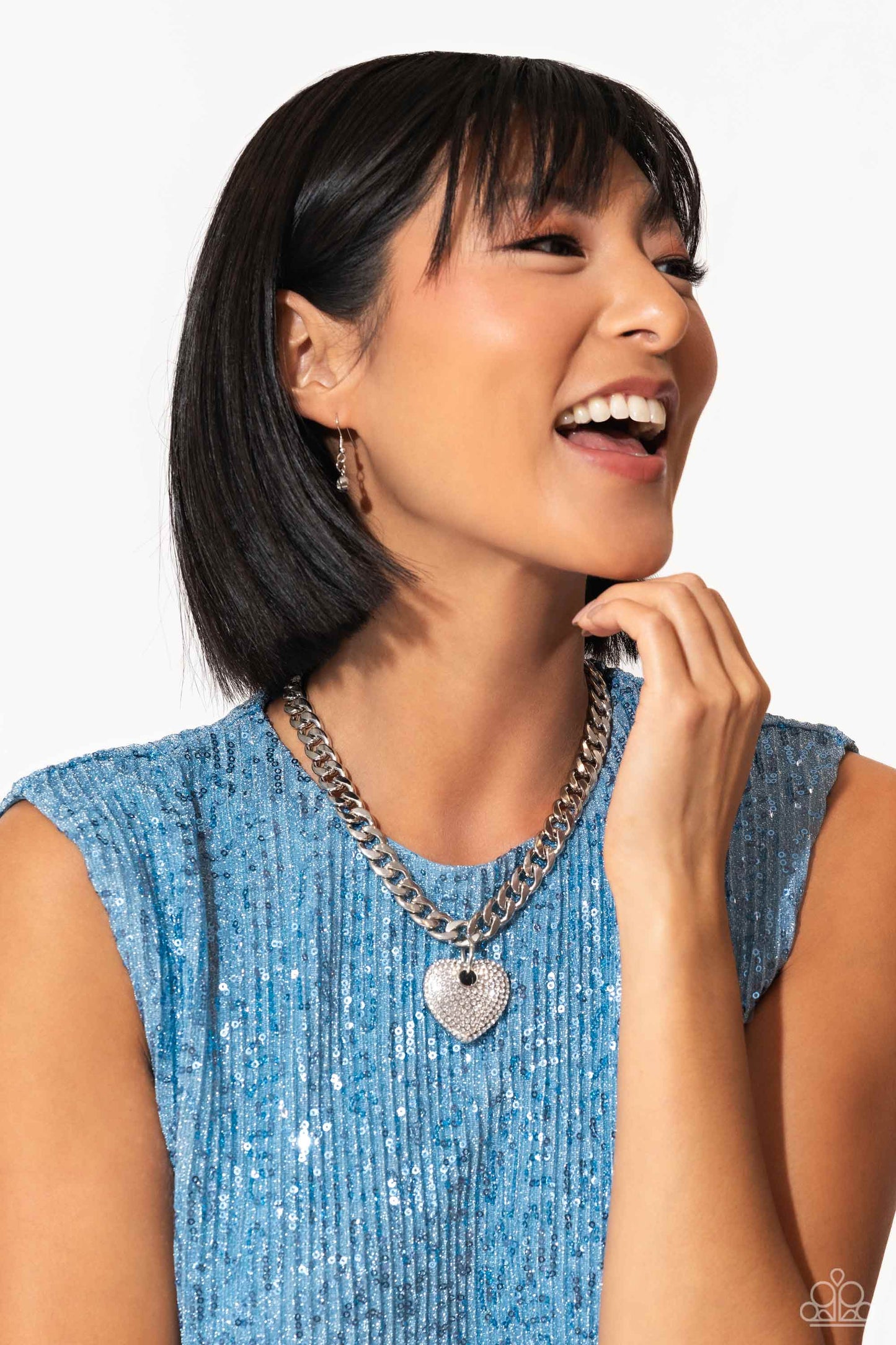 Ardent Affection White Heart Necklace - Paparazzi Accessories  Featuring an intense white rhinestone embellishment, an oversized silver heart frame swings from the bottom of a thick silver curb chain for an edgy declaration. Features an adjustable clasp closure.  Sold as one individual necklace. Includes one pair of matching earrings.  SKU: P2ST-WTXX-138XX  *LOP January 2024