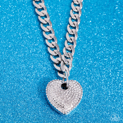 Ardent Affection White Heart Necklace - Paparazzi Accessories  Featuring an intense white rhinestone embellishment, an oversized silver heart frame swings from the bottom of a thick silver curb chain for an edgy declaration. Features an adjustable clasp closure.  Sold as one individual necklace. Includes one pair of matching earrings.  SKU: P2ST-WTXX-138XX  *LOP January 2024