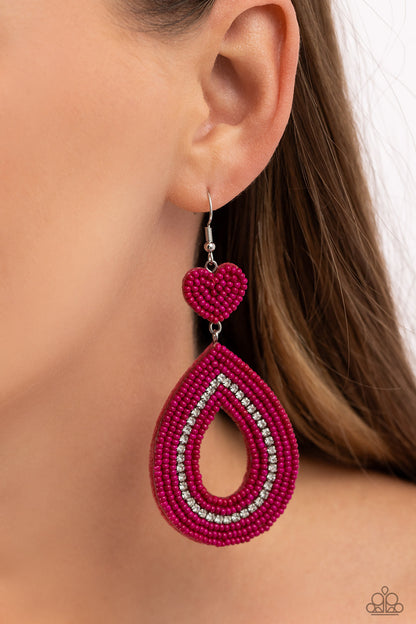 Now SEED Here Pink Heart Seed Bead Necklace - Paparazzi Accessories  Featuring white rhinestone accents, hot pink seed beads adorn the surface of a teardrop frame that swings from the bottom of a hot pink seed bead heart, creating a colorful lure. Earring attaches to a standard fishhook fitting.  Sold as one pair of earrings.  SKU: P5ST-PKXX-035XX