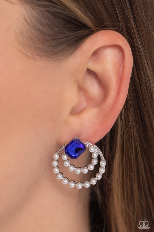 Double Standard Blue Post Earring - Paparazzi Accessories  Infused with dainty bubbly white pearls, a silver double hoop frame swings from a solitaire emerald-cut blue gem, haphazardly placed at the top of the joined hoops, creating a vintage display. Earring attaches to a standard post fitting.  Sold as one pair of post earrings.  P5PO-BLXX-163XX
