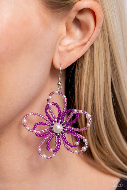 PEARL Crush Purple Seed Bead Flower Earring - Paparazzi Accessories  A glossy white pearl blooms from the center of a layered Rose Violet and plum glassy seed bead flower, infused with additional dainty white pearls, creating a colorful floral frame. Earring attaches to a standard fishhook fitting.  Sold as one pair of earrings.  SKU: P5ST-PRXX-027XX