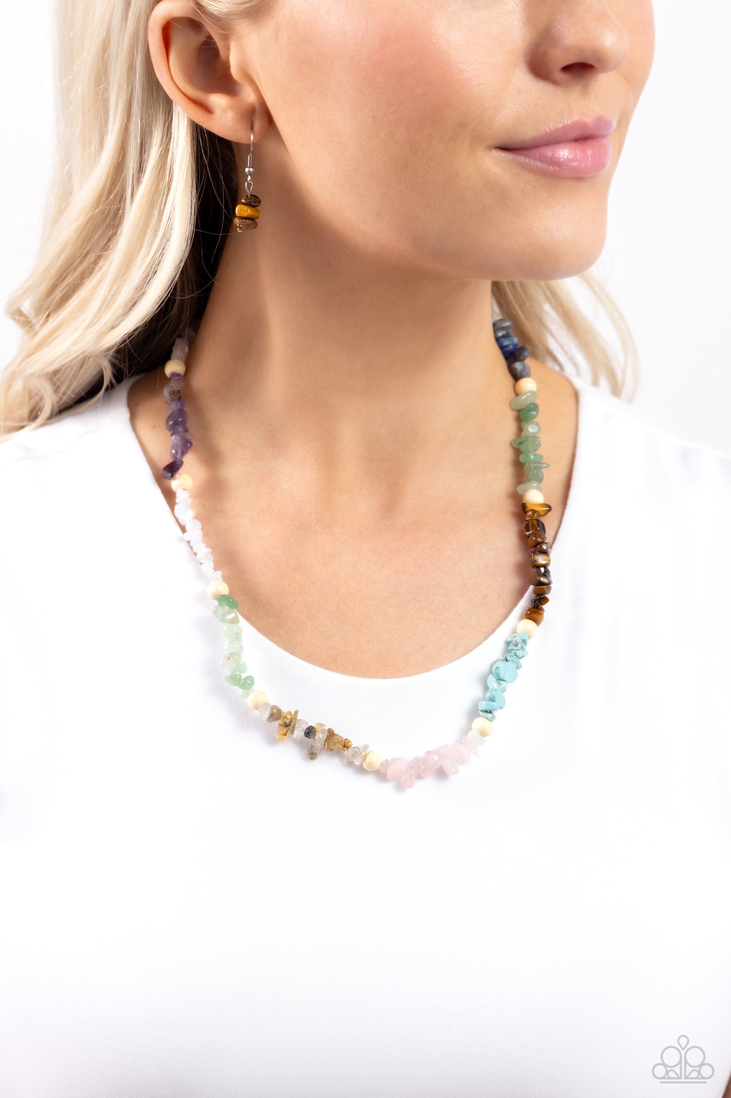 Soothing Stones Multi Necklace - Paparazzi Accessories  Infused on an invisible wire, chiseled turquoise, jade, rose quartz, lapis, amethyst, clear white, gray, and tiger's eye stones coalesce around the collar for a colorfully, earthy statement. White wood beads sporadically dot amongst the chiseled collection for an additional artisanal touch. Features an adjustable clasp closure. As the stone elements in this piece are natural, some color variation is normal.