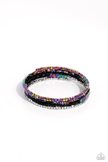 Dainty Dancer Black Coil Infinity Wrap Bracelet - Paparazzi Accessories  A glittery collection of metallic oil spill-like beads, black, silver, and gold beads, and oil spill square and cubed accents are coiled along an invisible wire around the wrist for a prismatic finish.  Sold as one individual bracelet.  P9DA-BKXX-160XX