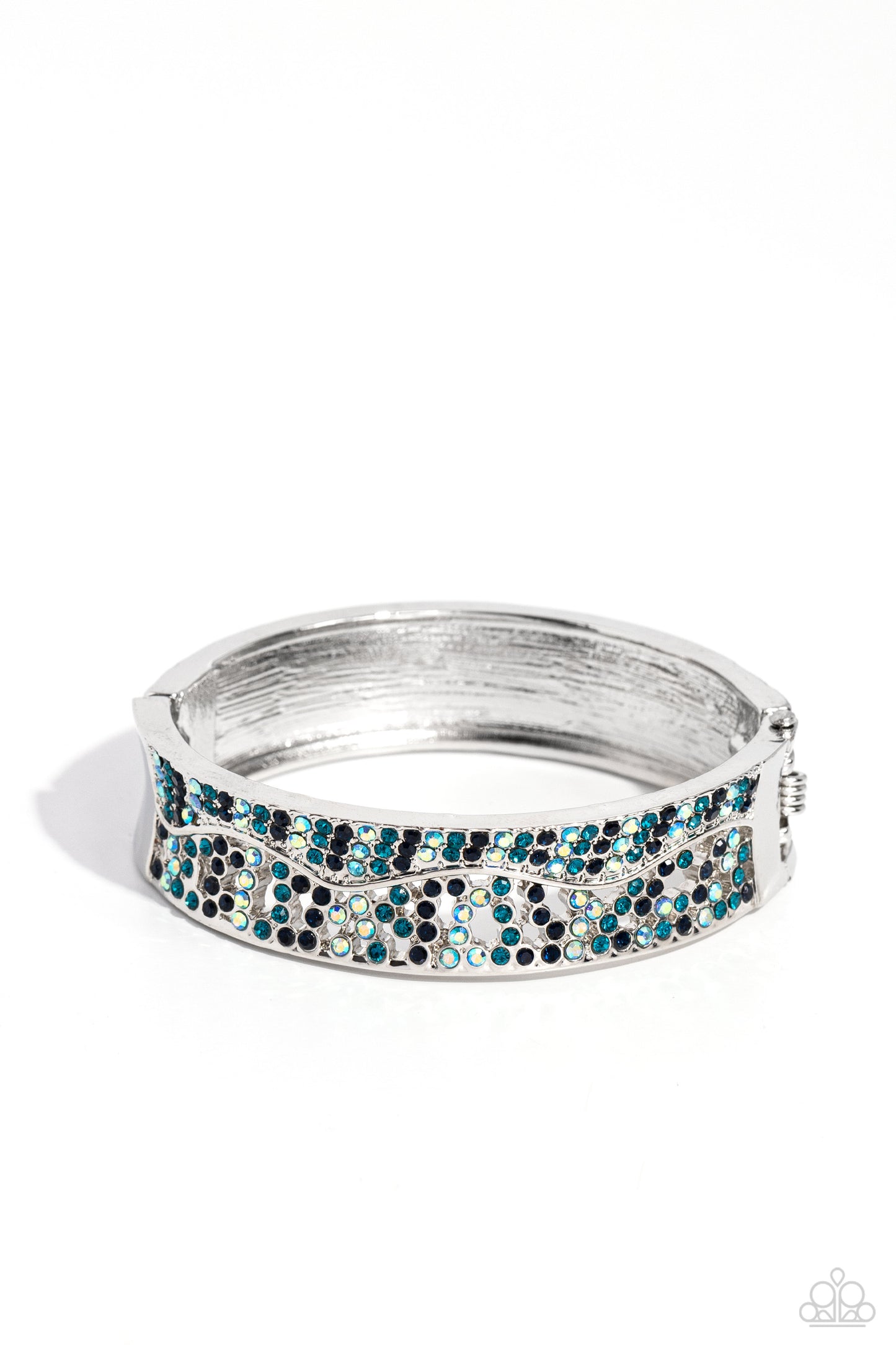 Wavy Whimsy Blue Hinge Bracelet - Paparazzi Accessories  Dusted in sections of dainty Montana, blue iridescent, and blue rhinestones, asymmetrically wavy thick silver bars boldly cross around the wrist in an airy pattern creating a gritty yet glamorous cuff.  Sold as one individual bracelet.  Sku:  P9RE-BLXX-243XX