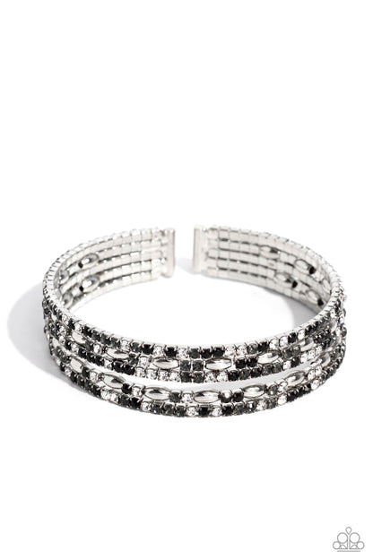 Endless Energy Black Cuff Bracelet - Paparazzi Accessories  Four strands of dazzling white, black, and smoky rhinestones flank shiny silver accents, coalescing into a sparkly layered cuff around the wrist.  Sold as one individual bracelet.  SKU: P9DA-BKXX-161XX