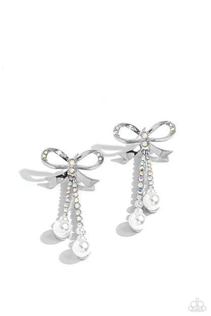 Bodacious Bow Multi Post Earring - Paparazzi Accessories  Adorned in sparkling iridescent rhinestones, high-sheen bands of silver curl and loop into a stunning bow charm, creating a classy statement at the ear. Iridescent rhinestones encased in scalloped silver fittings, featuring white pearls that slowly increase in size dangle from the bow charm adding a refined tassel to the stunning display. Earring attaches to a standard post fitting.  Sold as one pair of post earrings.  P5PO-MTXX-113XX