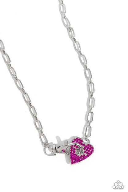 Radical Romance Pink Heart Necklace - Paparazzi Accessories  Featuring a subtly studded finish, a silver paperclip chain leads the eye down to a fuchsia rhinestone-encrusted heart. A fuchsia rhinestone-embellished lobster clasp connects to the center of the heart display for a touch of handcrafted hardware, creating a radiant centerpiece. Features a clasp closure.  Sold as one individual necklace. Includes one pair of matching earrings.  Sku:  P2DA-PKXX-186XX