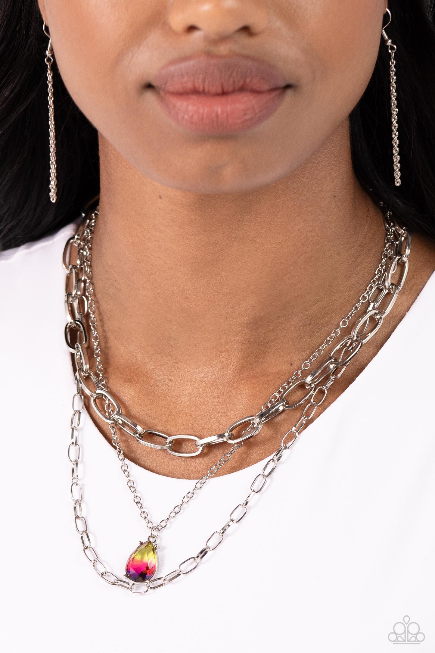 Teardrop Tiers Multi Necklace - Paparazzi Accessories  A trio of mismatched silver chains coalesces down the neckline for a monochromatic masterpiece. Strung on the middle chain, a pronged glassy teardrop with an ombré effect of yellow to pink to purple stands out and reflects light in every direction for a statement finish. Features an adjustable clasp closure.  Sold as one individual choker necklace. Includes one pair of matching earrings.  P2CH-MTXX-046XX