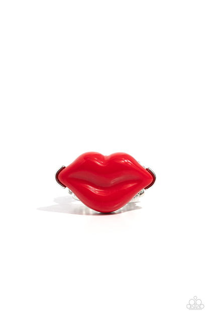 Lively Lips Red Ring - Paparazzi Accessories  Featured atop airy silver bands, a pair of red acrylic lips stands out atop the finger for a vibrant, carefree finish. Features a stretchy band for a flexible fit.  Featured inside The Preview at Made for More!  Sold as one individual ring.  Sku:  P4ST-RDXX-015XX