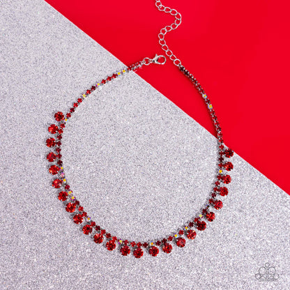 Ritzy Rhinestones Red Choker Necklace - Paparazzi Accessories  A single strand of various dainty red and red iridescent rhinestones in dainty square fittings coalesce around the collar. Faceted red gems are pronged in place as they drip from the dazzling row above for a ritzy finish. Features an adjustable clasp closure. Due to its prismatic palette, color may vary.  Sold as one individual choker necklace. Includes one pair of matching earrings.  SKU: P2CH-RDXX-029XX