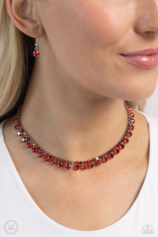 Ritzy Rhinestones Red Choker Necklace - Paparazzi Accessories  A single strand of various dainty red and red iridescent rhinestones in dainty square fittings coalesce around the collar. Faceted red gems are pronged in place as they drip from the dazzling row above for a ritzy finish. Features an adjustable clasp closure. Due to its prismatic palette, color may vary.  Sold as one individual choker necklace. Includes one pair of matching earrings.  SKU: P2CH-RDXX-029XX