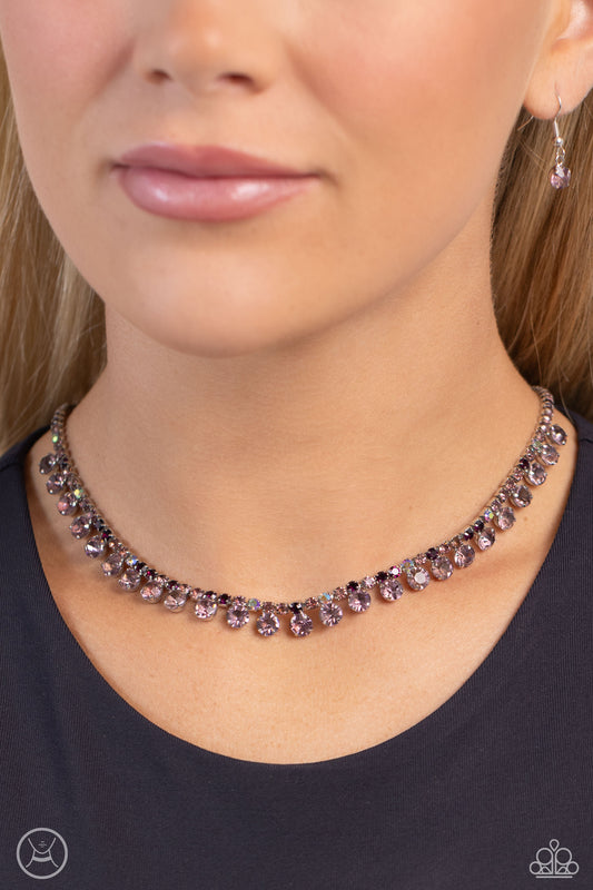 Ritzy Rhinestones Purple Choker Necklace - Paparazzi Accessories  A single strand of various dainty amethyst and amethyst iridescent rhinestones in dainty square fittings coalesce around the collar. Faceted amethyst gems are pronged in place as they drip from the dazzling row above for a ritzy finish. Features an adjustable clasp closure. Due to its prismatic palette, color may vary.