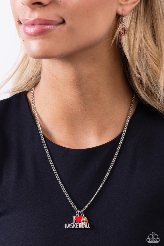 Making Buckets Orange Basketball Necklace - Paparazzi Accessories  Dangling along a classic silver chain, a charm spelling out "I [Heart] Basketball" with a red-painted heart charm rests along the neckline. Infused along the chain, an orange basketball charm adds a sporty finish to the design. Features an adjustable clasp closure.  Sold as one individual necklace. Includes one pair of matching earrings.  P2WH-OGXX-272XX