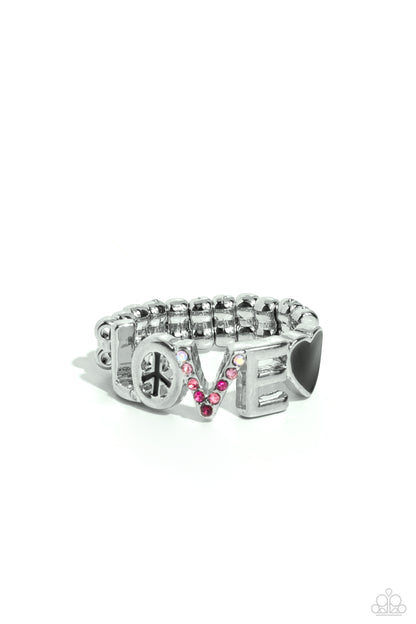 Unlimited Love Black Peace Sign Ring - Paparazzi Accessories  Glistening silver letters arc across the finger, forming the word "LOVE" for a causally romantic finish. The letter "O" features a black-painted peace sign, the letter "V" features various shades of pink and iridescent rhinestones, while a black-painted heart caps the word, infusing the design with color. Features a dainty stretchy band for a flexible fit. Due to its prismatic palette, color may vary.
