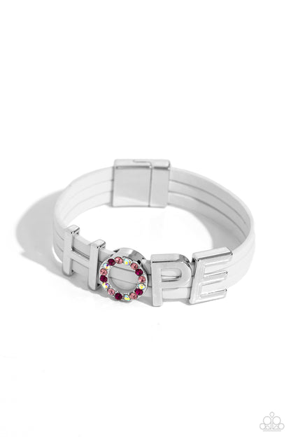 Hopeful Haute White Magnetic Bracelet - Paparazzi Accessories  Threaded along layers of white leather strands, glistening silver letters form the word "HOPE" with the "O" embossed in various shades of pink and pink iridescent rhinestones for a dazzling statement. Features a magnetic closure. Due to its prismatic palette, color may vary.  Sold as one individual bracelet.  SKU: P9SE-WTXX-262XX