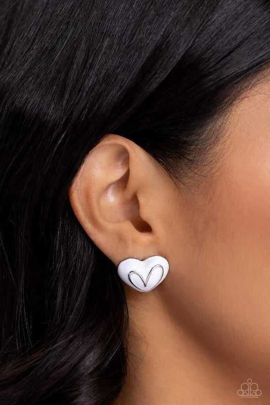 Glimmering Love White Heart Post Earring - Paparazzi Accessories  Featuring a silver hue, two thick white-painted heart frames are adorned with the word "love" in a script font and a loopy heart outline for a flirtatious mix-and-match look. Earring attaches to a standard post earring.  Sold as one pair of post earrings.  SKU: P5PO-WTXX-384XX