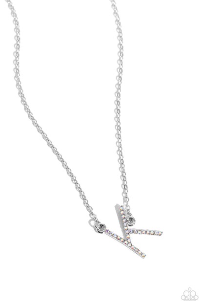 INITIALLY Yours Multi "K" Necklace - Paparazzi Accessories  Embossed with dainty iridescent rhinestones, a silver letter "K" hovers below the collar from a dainty silver chain, for a sentimentally simple design. Features an adjustable clasp closure. Due to its prismatic palette, color may vary.  Sold as one individual necklace. Includes one pair of matching earrings.  P2DA-MTXX-134XX