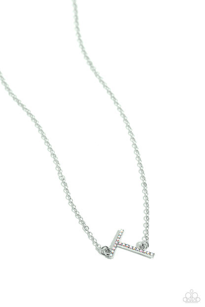 INITIALLY Yours Multi "T" Necklace - Paparazzi Accessories  Embossed with dainty iridescent rhinestones, a silver letter "T" hovers below the collar from a dainty silver chain, for a sentimentally simple design. Features an adjustable clasp closure. Due to its prismatic palette, color may vary.  Sold as one individual necklace. Includes one pair of matching earrings.  P2DA-MTXX-143XX