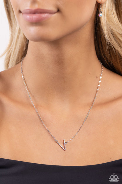 INITIALLY Yours Multi "V" Necklace - Paparazzi Accessories  Embossed with dainty iridescent rhinestones, a silver letter "V" hovers below the collar from a dainty silver chain, for a sentimentally simple design. Features an adjustable clasp closure. Due to its prismatic palette, color may vary.  Sold as one individual necklace. Includes one pair of matching earrings.  P2DA-MTXX-145XX