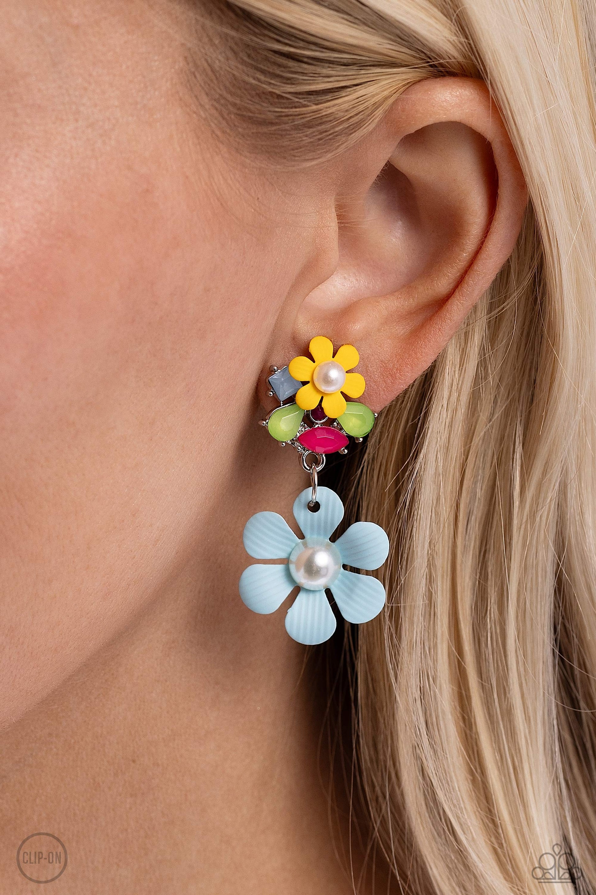 Festive Florals Blue Clip-On Earring - Paparazzi Accessories  Featuring Pantones® Kohlrabi, Summer Song, Pink Peacock, and Radiant Orchid, a collection of geometric, milky acrylic shapes cluster around a pearl-centered, dainty Daffodil Yellow flower for a spring-inspired pop of color. The abstract, multicolored display gives way to a larger pearl-centered, textured flower but in a Summer Song hue. Earring attaches to a standard clip-on fitting.  Sold as one pair of clip-on earrings.  SKU: P5CO-BLXX-066XX