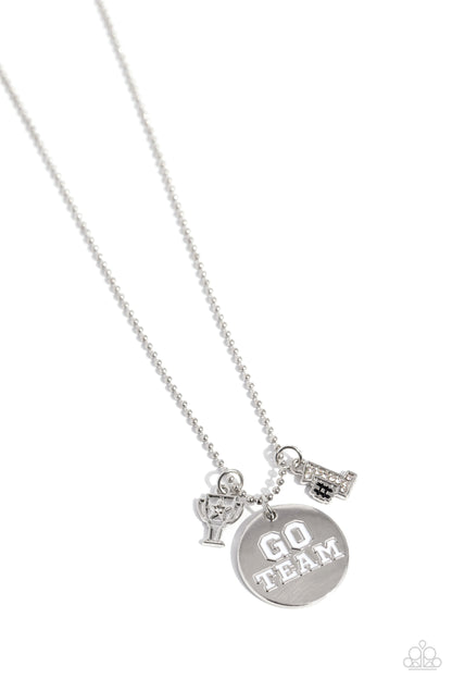 Go Team! White Necklace - Paparazzi Accessories  Gliding along a silver ball chain, a trophy charm with a rhinestone-embellished star, a #1 charm embossed in white rhinestones, and a silver disc with the white-painted phrase "Go Team" on it coalesces below the collar for a spirited statement. Features an adjustable clasp closure.  Sold as one individual necklace. Includes one pair of matching earrings.  P2WH-WTXX-320XX