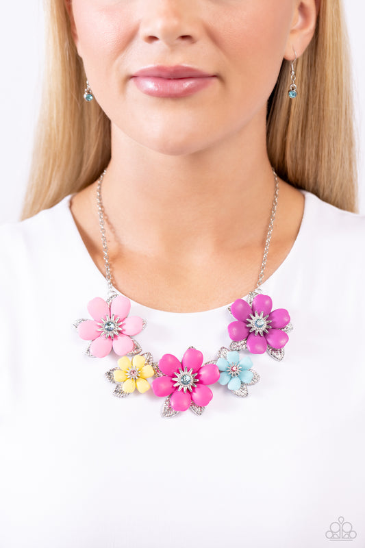Well-Mannered Whimsy Multi Flower Necklace - Paparazzi Accessories  Dotted with dainty light amethyst, aquamarine, and rose rhinestone centers, dainty silver flowers bloom against a backdrop of glossy acrylic flowers in Aurora Pink, Rose Violet, hot pink, yellow, and Spun Sugar hues. Each flower, varying in size, blossoms across a textured collection of silver leaves below the collar, invoking a festive spirit. Features an adjustable clasp closure.