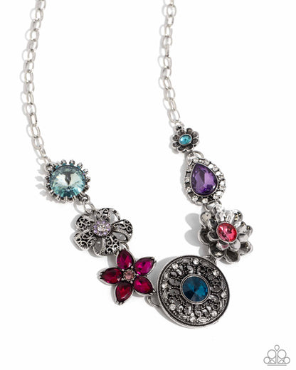 Giddy Garden Multi Flower Necklace (March 2024 LOP) - Paparazzi Accessories A variety of floral-inspired pendants featuring intricate detailing. Silver flowers featuring colorful gem centers and petals, followed by an airy filigree flower with a glistening rhinestone center. Two faceted round and teardrop gems are encircled by classic white rhinestones. Silver and white rhinestones radiate from a blue gem, creating the centermost pendant. Includes one pair of matching earrings. SKU: P2ST-MTXX-141XX