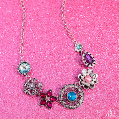 Giddy Garden Multi Flower Necklace (March 2024 LOP) - Paparazzi Accessories A variety of floral-inspired pendants featuring intricate detailing. Silver flowers featuring colorful gem centers and petals, followed by an airy filigree flower with a glistening rhinestone center. Two faceted round and teardrop gems are encircled by classic white rhinestones. Silver and white rhinestones radiate from a blue gem, creating the centermost pendant. Includes one pair of matching earrings. SKU: P2ST-MTXX-141XX