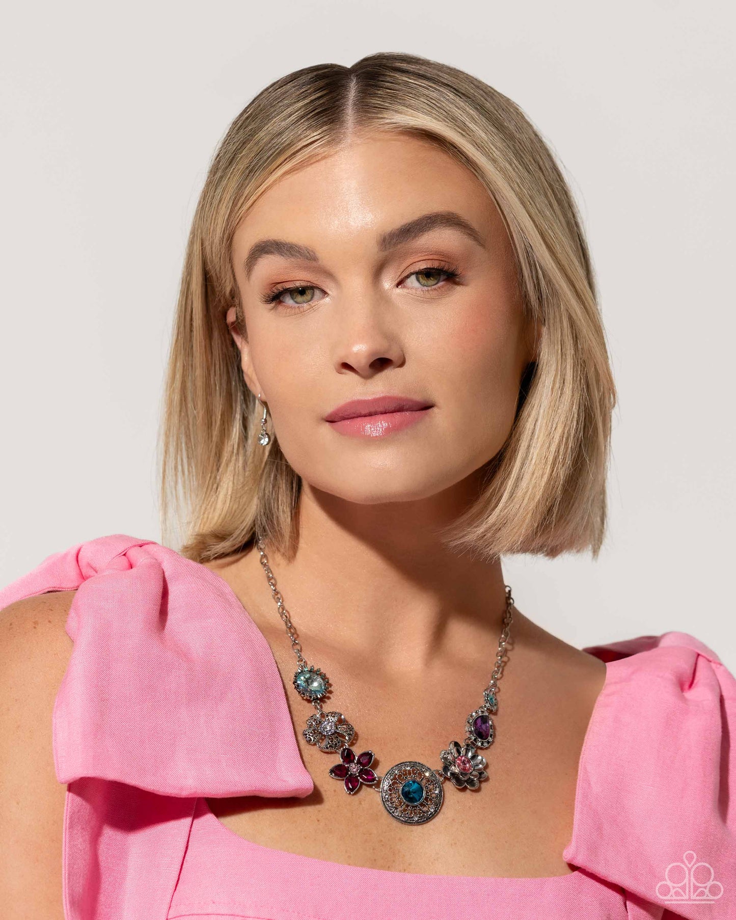 Giddy Garden Multi Flower Necklace (March 2024 LOP) - Paparazzi Accessories A variety of floral-inspired pendants featuring intricate detailing. Silver flowers featuring colorful gem centers and petals, followed by an airy filigree flower with a glistening rhinestone center. Two faceted round and teardrop gems are encircled by classic white rhinestones. Silver and white rhinestones radiate from a blue gem, creating the centermost pendant. Includes one pair of matching earrings. SKU: P2ST-MTXX-141XX
