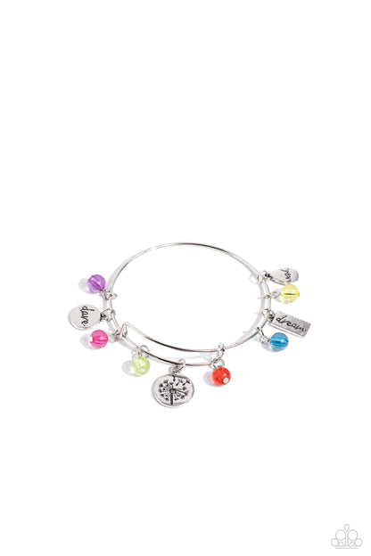 Dedicated Dandelion Multi Inspirational Bangle Bracelet - Paparazzi Accessories  A collection of various shimmery silver discs, each featuring the stamped words "dare," "wish," and "dream," combines with clear, glassy apple green, orange, turquoise, yellow, purple, and hot pink beads as they slide along a sleek bar fitting, on a dainty silver bangle. A larger disc, stamped with a dandelion motif finishes off the charming design with a sentimental statement.