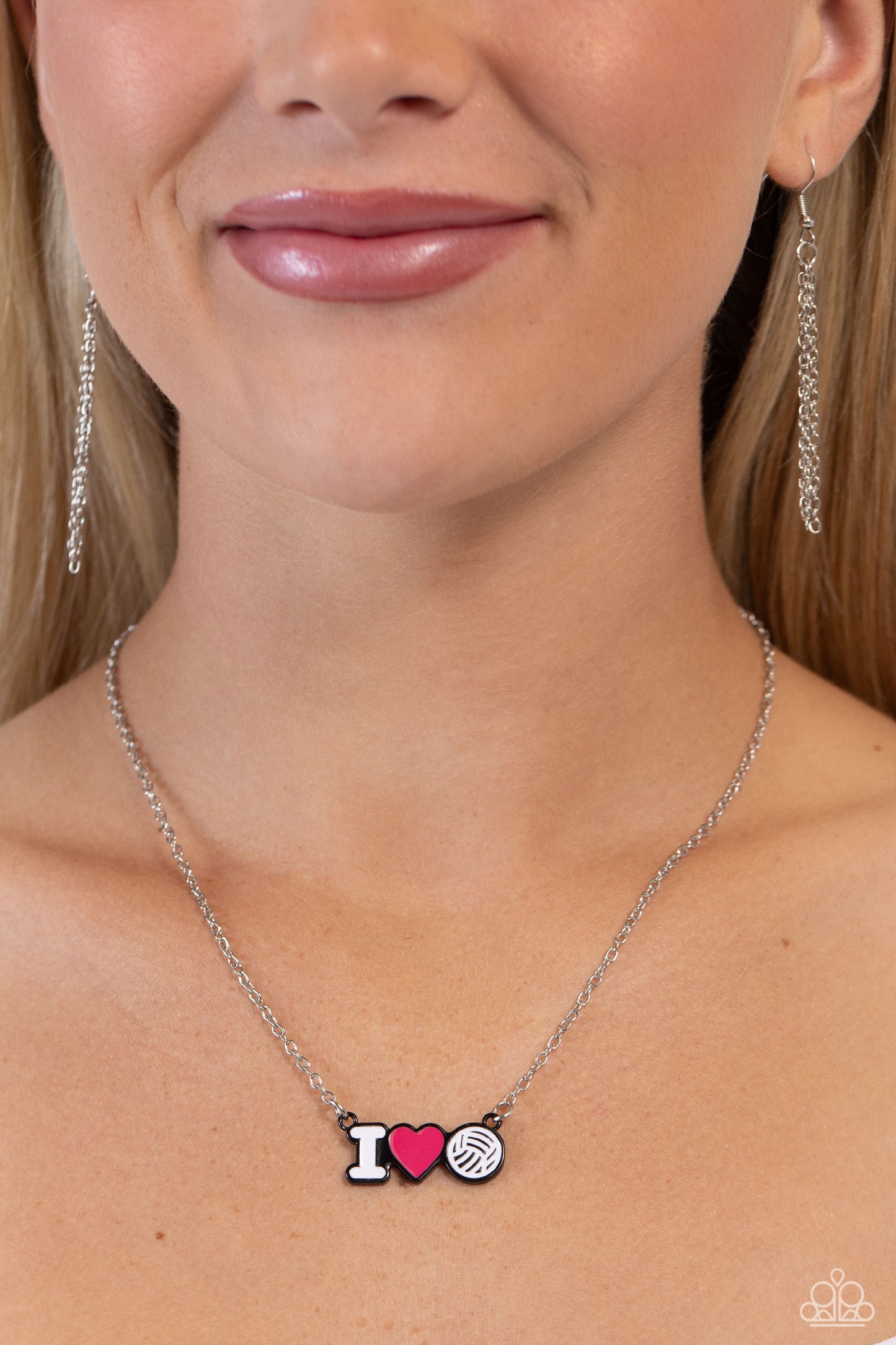 Meet Me at the Net Pink Necklace - Paparazzi Accessories  Cascading from a dainty silver chain, a white-painted "I," a pink heart, and a white volleyball charm lay beside one another in black-painted frames for a sports-inspired display. Features an adjustable clasp closure.  Sold as one individual necklace. Includes one pair of matching earrings.  P2DA-PKXX-200XX