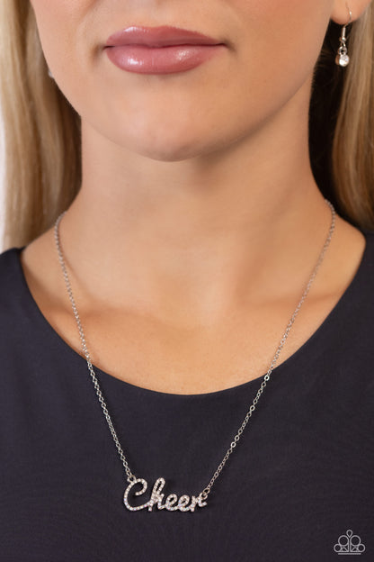 Cheer Squad White Necklace - Paparazzi Accessories  Curled in a script font, glistening silver letters spell out the word "Cheer" along a dainty silver chain. Embossed on the letters, dainty white rhinestones and iridescent rhinestones create a subtle ombré effect for a peppy finish. Features an adjustable clasp closure. Due to its prismatic palette, color may vary.  Sold as one individual necklace. Includes one pair of matching earrings.  P2WD-WTXX-276XX