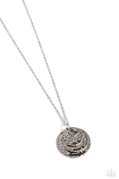 Keep Moving Forward Silver Inspirational Pray Necklace - Paparazzi Accessories  Featuring a hammered texture, a trio of silver discs layered atop one another ripple out into a dizzying pendant that gradually increases in size at the bottom of a silver chain. A sleek silver heart glides atop the layered discs, featuring the word "pray," completing the phrase stamped on each disc, including "on it," "over it," and "through it," for a religious-inspired finish. Features an adjustable clasp closure.
