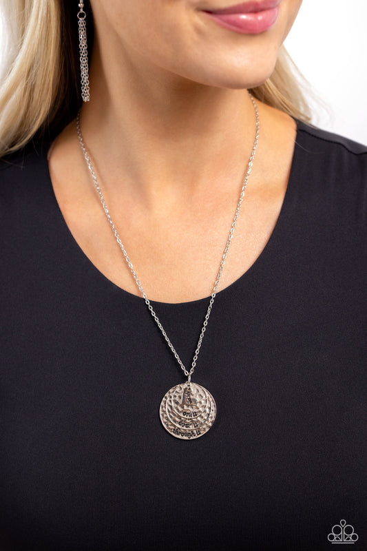 Keep Moving Forward Silver Inspirational Pray Necklace - Paparazzi Accessories  Featuring a hammered texture, a trio of silver discs layered atop one another ripple out into a dizzying pendant that gradually increases in size at the bottom of a silver chain. A sleek silver heart glides atop the layered discs, featuring the word "pray," completing the phrase stamped on each disc, including "on it," "over it," and "through it," for a religious-inspired finish. Features an adjustable clasp closure.