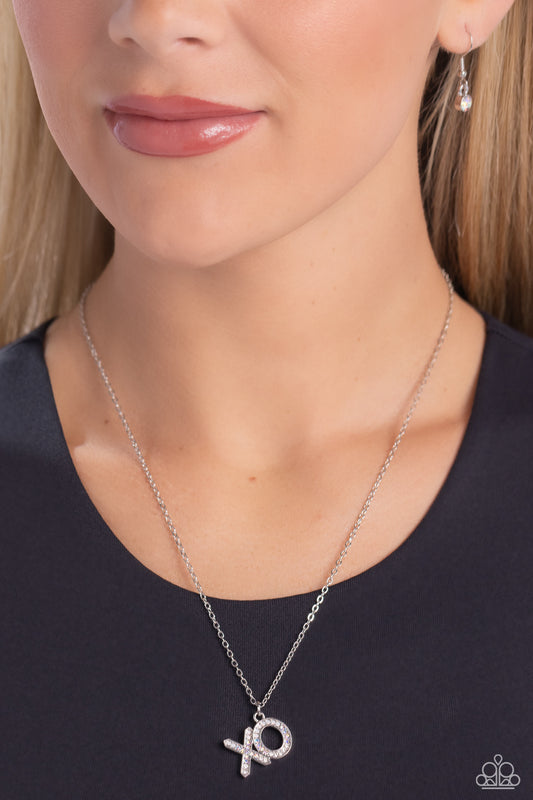 XO Showcase White Necklace - Paparazzi Accessories  Cascading from a dainty silver chain, the silver letters "XO" are embossed in various glistening white rhinestones, creating a romantic ombré statement down the neckline. Features an adjustable clasp closure. Due to its prismatic palette, color may vary.  Sold as one individual necklace. Includes one pair of matching earrings.  SKU: P2WD-WTXX-307XX