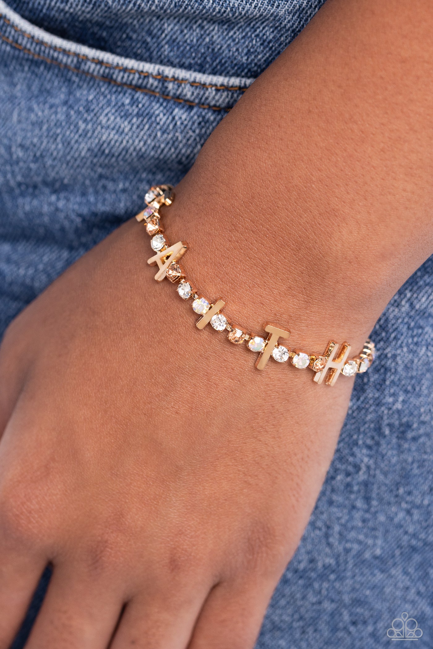 In Good Faith Gold Clasp Bracelet - Paparazzi Accessories  Set in gold square fittings, various multicolored rhinestones gleam around the wrist. Infused along the design, sleek gold letters spell out the word "FAITH" for an inspirational finish. Features an adjustable clasp closure. Due to its prismatic palette, color may vary.  Sold as one individual bracelet.  P9WD-GDXX-194XX