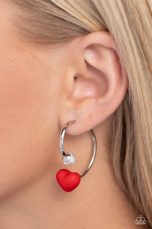 Romantic Representative Red Heart Jacket Earring - Paparazzi Accessories  A solitaire white pearl attaches to a double-sided post, designed to fasten behind the ear. Dotted with a red acrylic heart, the double-sided post peeks out beneath the ear for a romantic look. Earring attaches to a standard post fitting. Hoop measures approximately 1" in diameter.  Sold as one pair of double-sided hoop earrings.  SKU: P5HO-RDXX-030XX