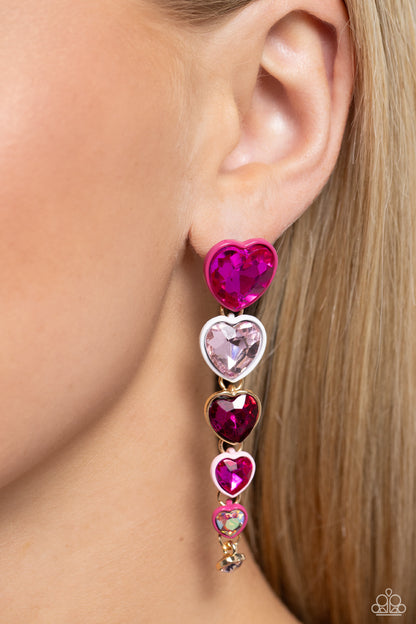 Cascading Casanova Pink Heart Post Earring - Paparazzi Accessories  Featuring sleek Pink Peacock, white, gold, and light pink-painted fittings, faceted fuchsia, white, and iridescent heart gems gradually decrease in size as they trickle from the ear for a glamorously romantic look. Earring attaches to a standard post fitting. Due to its prismatic palette, color may vary.  Sold as one pair of post earrings.  SKU: P5PO-PKXX-101XX