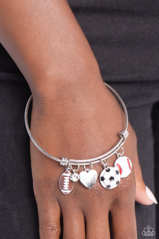 Seize the Sports Multi Bracelet - Paparazzi Accessories  Featuring a sporty motif, a silver heart, solitaire white rhinestone, and football, soccer ball, and baseball charms swing from a silver bangle-like bracelet attached to a sleek silver fitting for a spirited finish.  Sold as one individual bracelet.  P9BA-MTXX-051XX