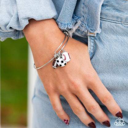 Seize the Sports Multi Bracelet - Paparazzi Accessories  Featuring a sporty motif, a silver heart, solitaire white rhinestone, and football, soccer ball, and baseball charms swing from a silver bangle-like bracelet attached to a sleek silver fitting for a spirited finish.  Sold as one individual bracelet.  P9BA-MTXX-051XX