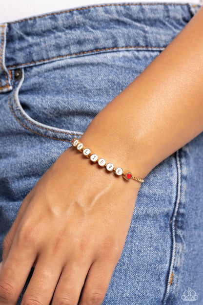 I Cant Believe It! Gold Sliding Bead Bracelet - Paparazzi Accessories  Delicately attached to a dainty gold box chain, thick circular gold fittings spell out the word "BELIEVE" across a white-painted backdrop with red-painted hearts embellishing the ends of the word, creating a sleek inspiring display. Features an adjustable sliding bead closure.  Sold as one individual bracelet.  Sku:  P9WD-GDXX-197XX